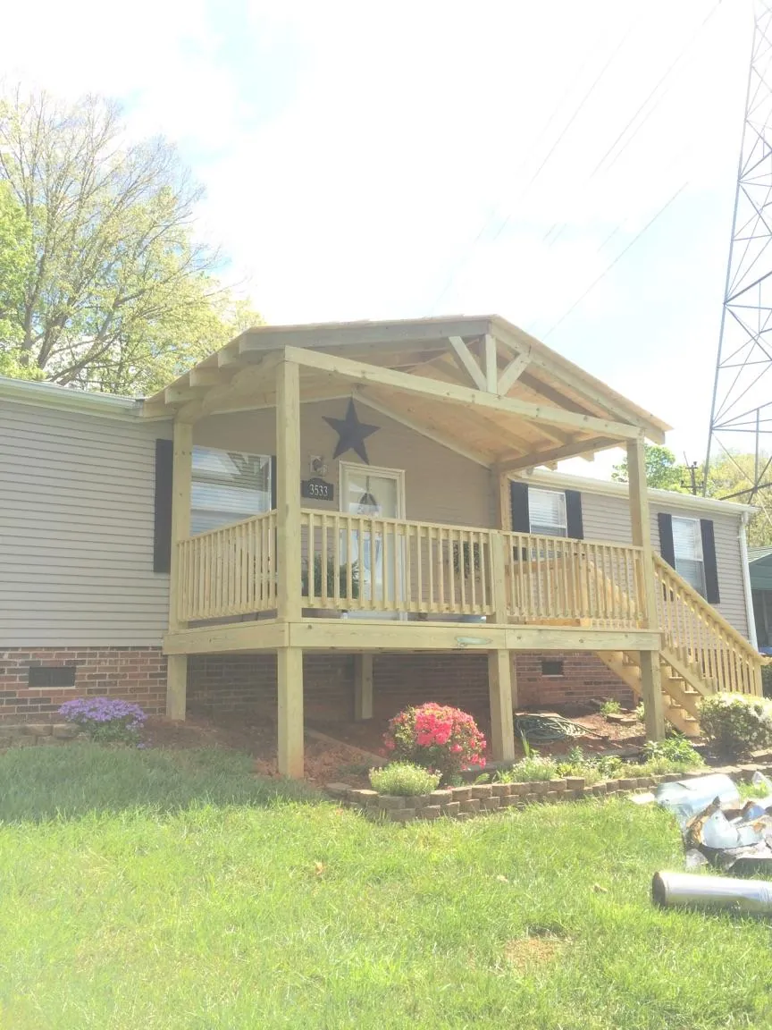 New gabled porch roof and deck railing added to a ranch home in Junction City